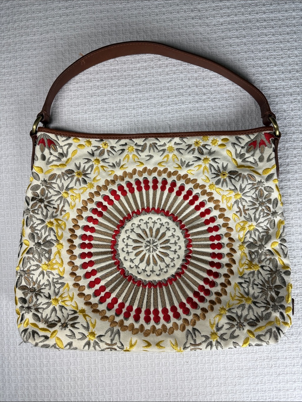 Cole Haan embroidered shoulder bag with leather accents and strap